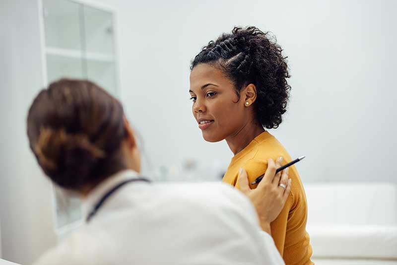 woman talking with doctor - mna womens health clinic